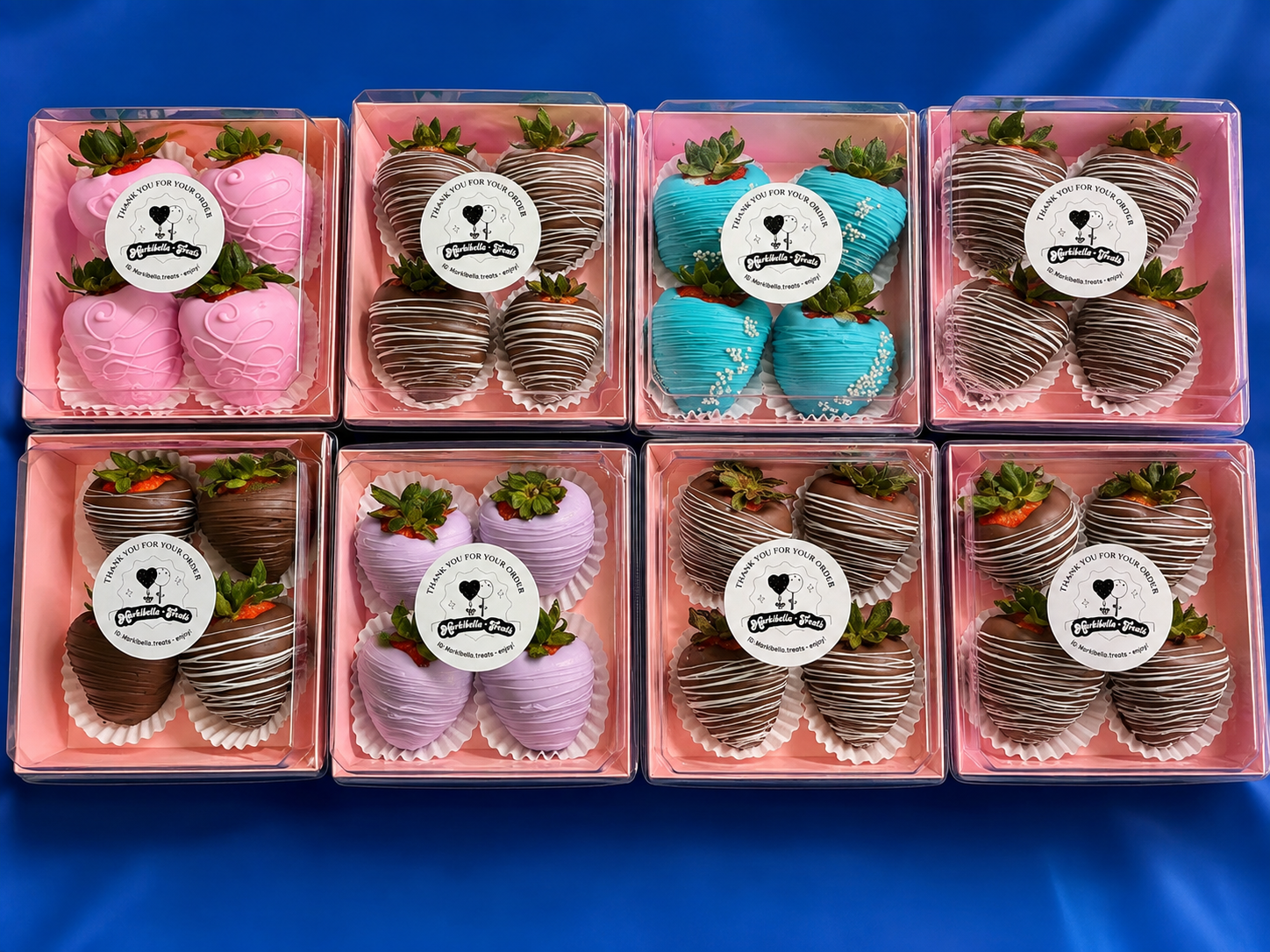 Eight four-count strawberry boxes in pink, lavender, blue and chocolate drizzle